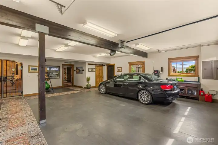 Incredible garage space with custom finishes, workshop potential, and direct access to the wine room, 3/4 bath, kitchenette, and huge entertainment room.