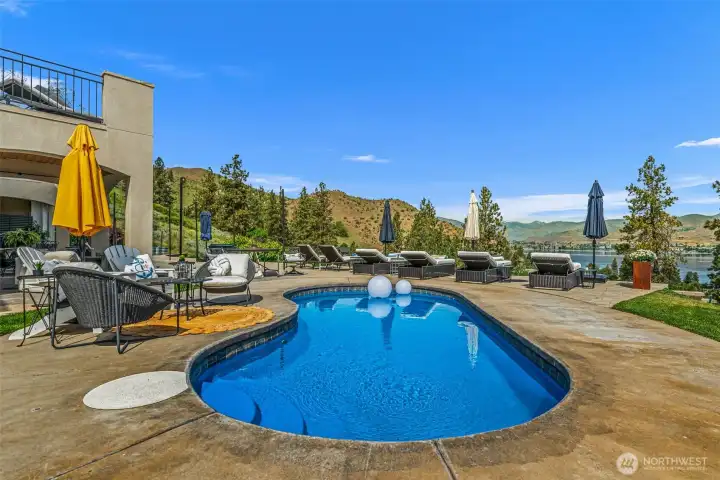 Private pool oasis surrounded by sunshine, mountain vistas, and sweeping lake views