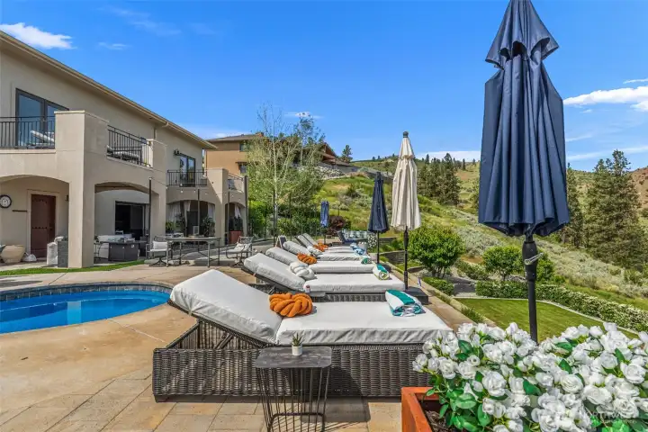 Expansive sun deck surrounding the pool creates the ultimate setting for summer entertaining and relaxation