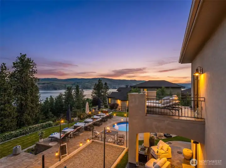 Sunset skies, sparkling pool lights, and sweeping lake views create the ultimate evening retreat