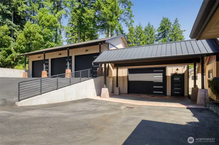 Carport leading to 1 of 4 large garage bays - workout/shop space