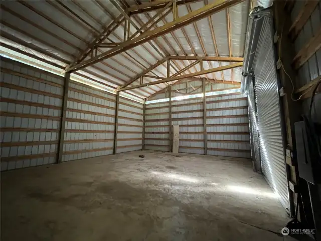 From the kitchen area, man-door to the large clear span shop.