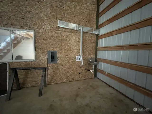 There's even a sink in the shop and connectionss for hot/cold water.  Leftover exhaust for propane stove.  Window into the office area.