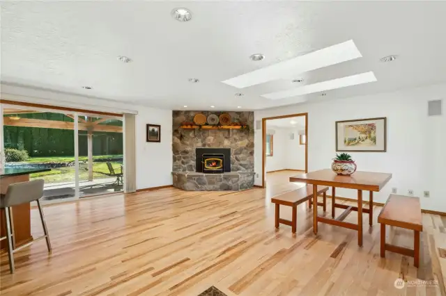 Gleaming real hardwood floors enhanced by the abundant natural light and the warmth of a wood burning fireplace.