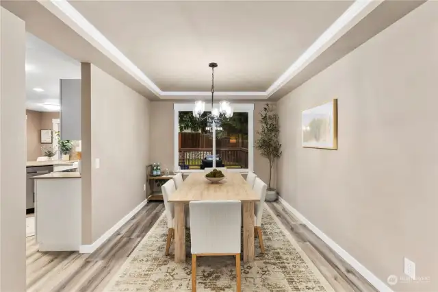 Dining area bathed in natural light, with stylish new fixtures.