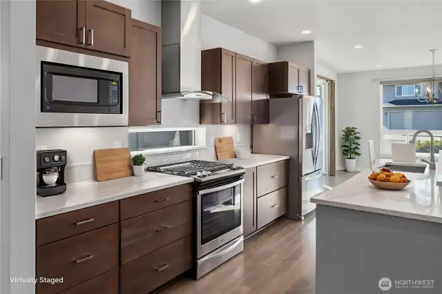 The kitchen blends sleek design with natural warmth.