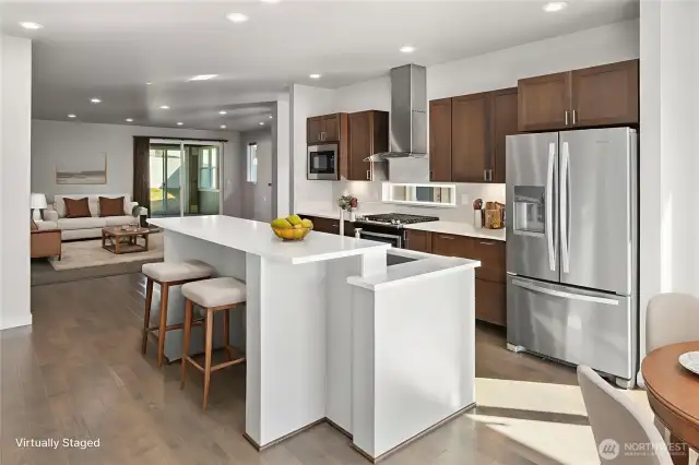 A spacious island serves as the centerpiece, offering ample prep space and casual seating for gatherings.