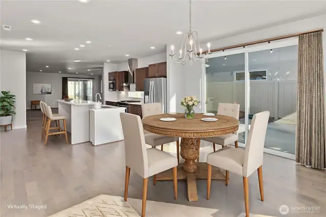 Large windows and glass doors flood the room with natural light