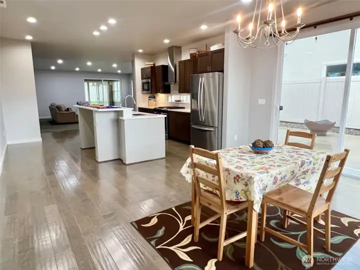 Large windows and glass doors flood the room with natural light