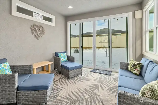 The enclosed porch extends the living area, providing a peaceful retreat to enjoy the outdoors year-round.