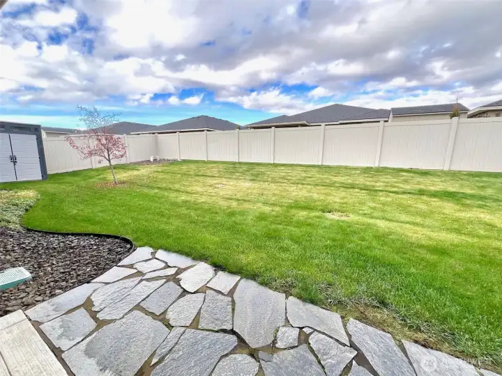 Grassy area that provides plenty of space for play, relaxation, or pets to roam freely
