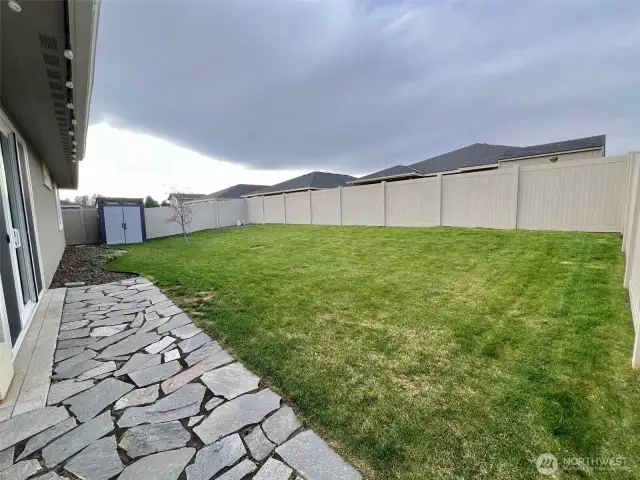 Grassy area that provides plenty of space for play, relaxation, or pets to roam freely
