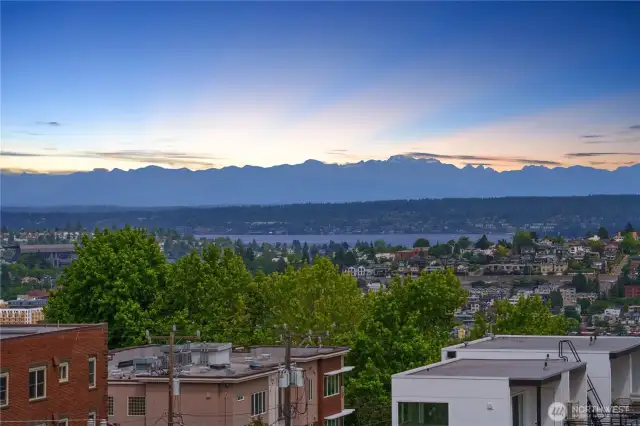 Imagine waking up daily to this sunrise. 180 degree views of the Cascades, Lake Washington, downtown and Mt. Rainier