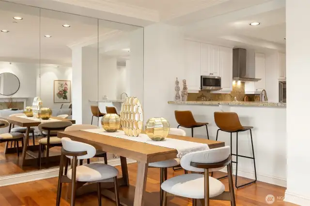A bartop for guests to visit with the chef, as well as formal dining space. Dining room easily holds much larger table.