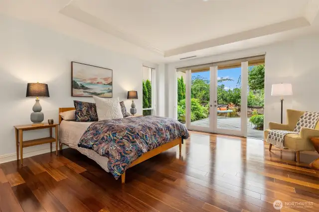 The warm wood floors beautifully complement the light and bright Primary, with it's coved ceiling craftsman detail.