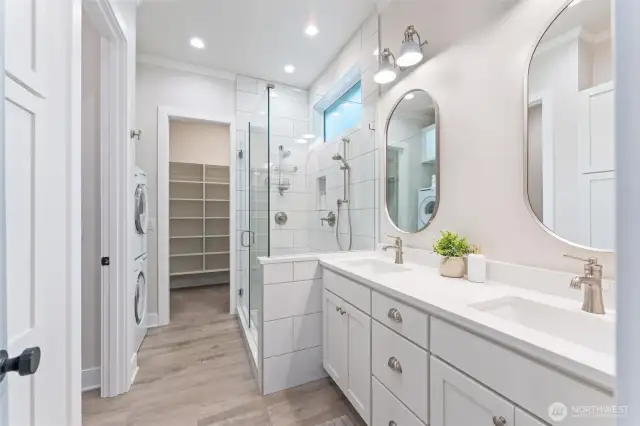 Primary bathroom with oversized walking closet and washer/dryer.