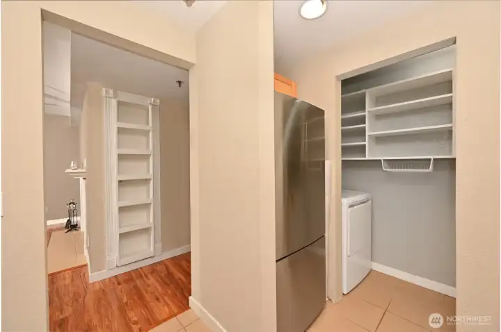 The shelving above the washer/dryer offers additional pantry storage.