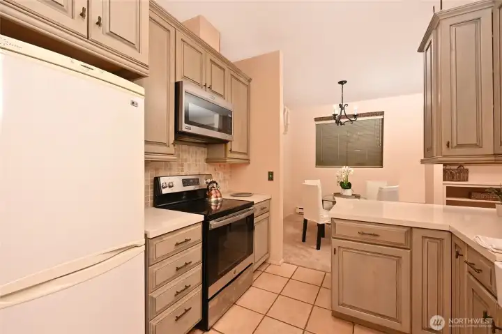 The kitchen has ample cupboard and counter space. All appliances stay.