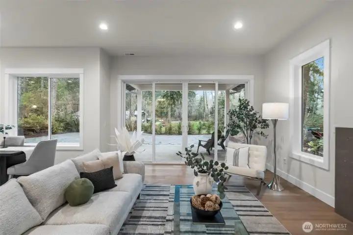 View thru the great room into the large back yard and patio