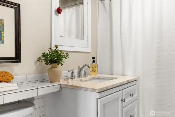 Main bathroom has updated classic tile