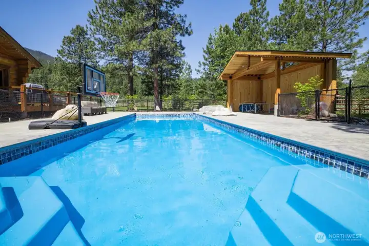 Private pool area with surrounding patio and recreation space—perfect for summer enjoyment and entertaining.