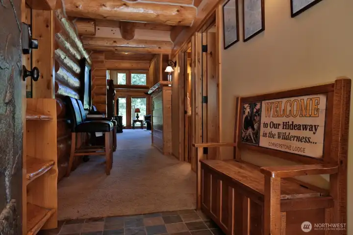 Inviting entry corridor with rich wood details draws you toward the light-filled great room.