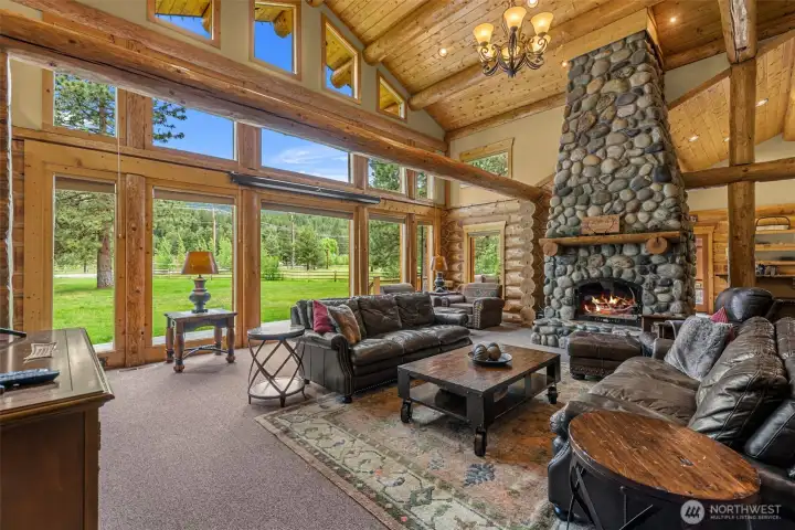 Expansive Living Room with Floor to Ceiling Rock Fireplace