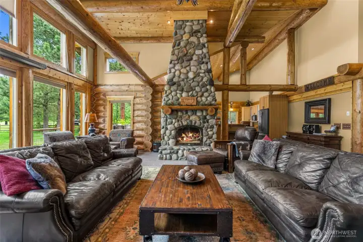 Expansive Living Room with Floor to Ceiling Rock Fireplace