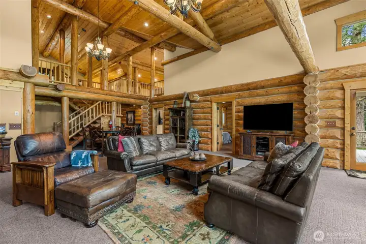 Expansive Living Room with Floor to Ceiling Rock Fireplace