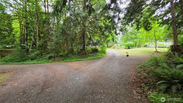 Stay straight (to the left) here. Property is the gray house in photo.