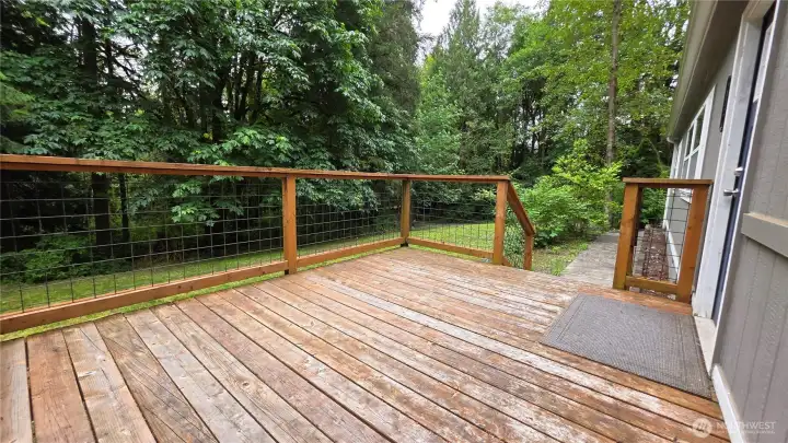 Huge deck at front entry offers private enjoyment of your yard and woods