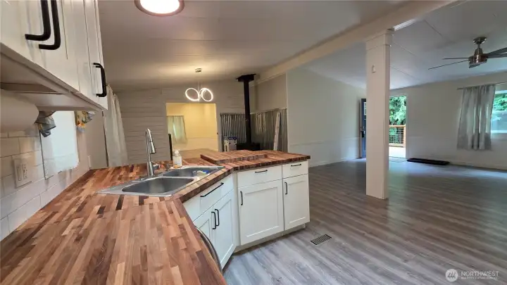 Butcher block counters span the entire wall and peninsula - there is a large, matching cutting board on the peninsula for the chef in the house