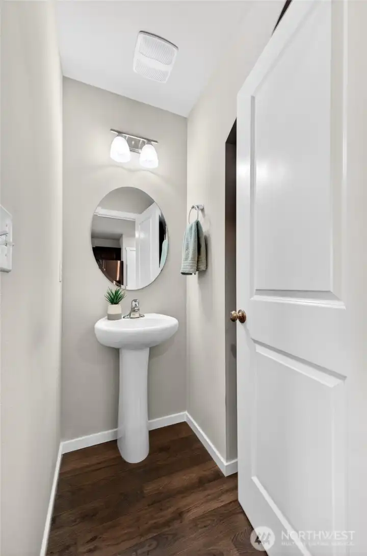 ½ bathroom conveniently located on main level perfect for guests. Toilet to the right behind the door.