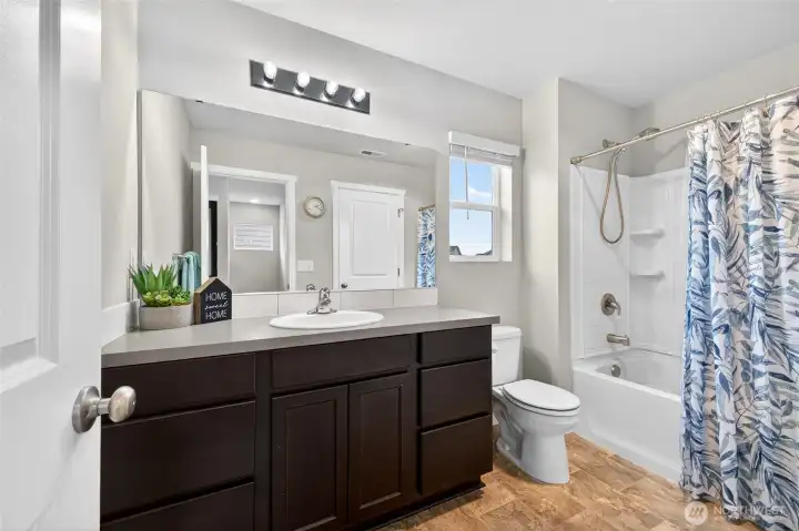 Large bathroom with a tub/shower combination.