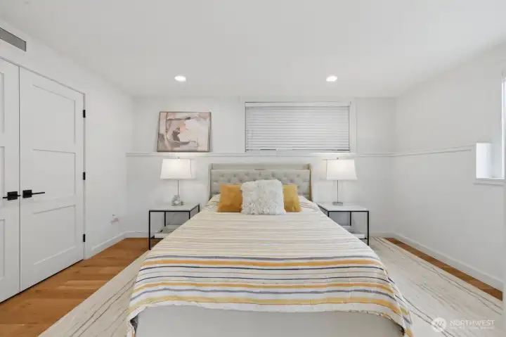 The lower level features a private guest suite w/ an adjacent full bath & a spacious rec room, offering flexibility for guests, multi-generational living, or a dedicated work-from-home setup.