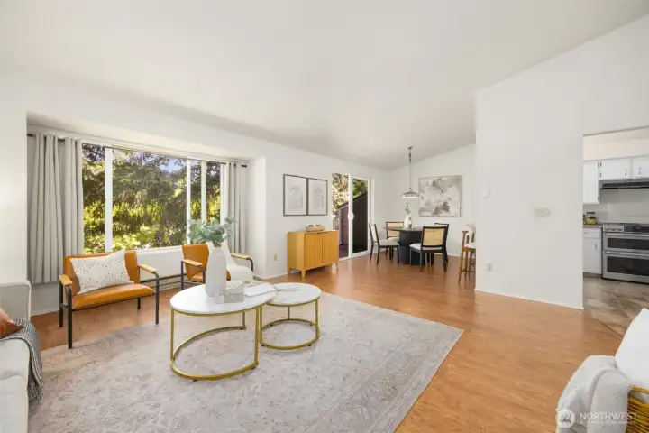 A wall of windows frames a lush evergreen backdrop with views of Tiger Mountain.