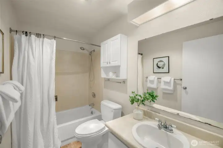 Clean lines and a full tub highlight this well-kept guest bath.