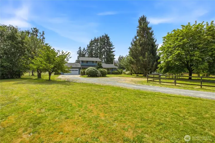 Driveway to home.  Fenced pasture on the right.