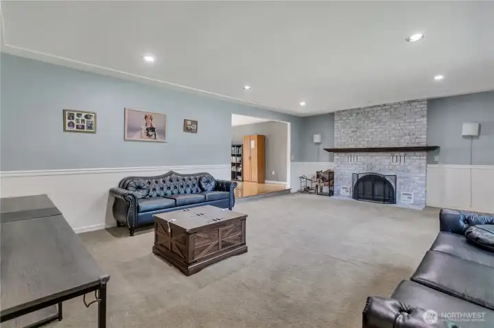 Living room with wood burning fireplace.