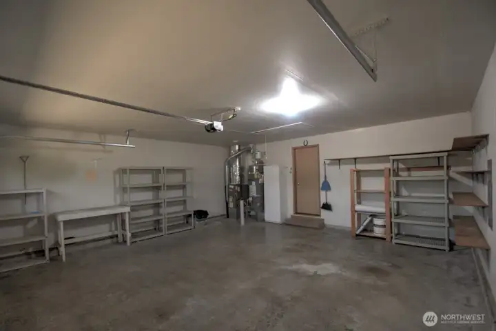 Oversized garage with lots of shelving