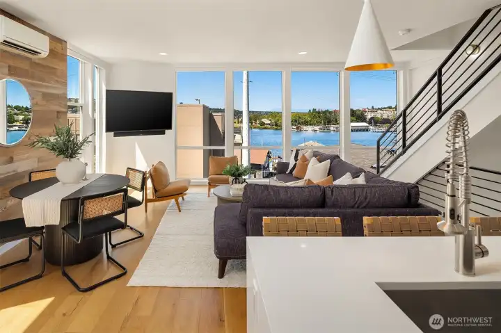 The entertaining level is located on the second floor and features an open-concept layout, gorgeous hardwood floors, and walls of windows that fill the space with natural light while showcasing the stunning views. The entertaining level is located on the second floor and features an open-concept layout, gorgeous hardwood floors, and walls of windows that fill the space with natural light while showcasing the stunning views.
