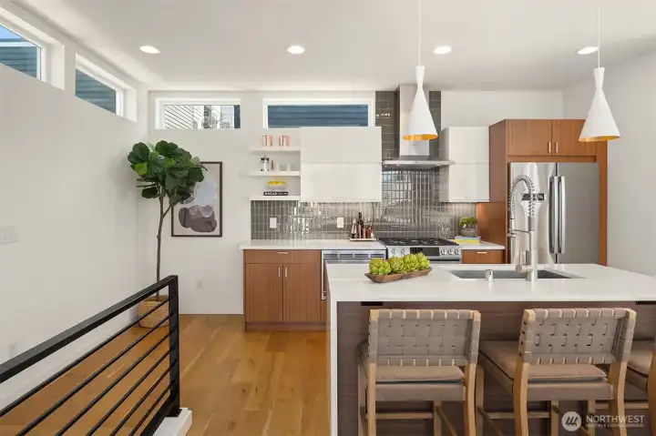 The spacious kitchen features premium Bosch appliances, a gas range, quartz slab countertops, and a timeless tile backsplash, blending style and functionality. The spacious kitchen features premium Bosch appliances, a gas range, quartz slab countertops, and a timeless tile backsplash, blending style and functionality.