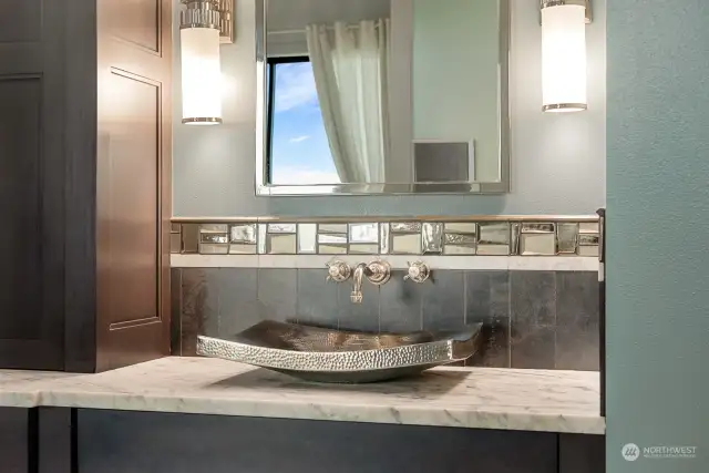 Gorgeous primary bath w/Carrera marble and heated floors. Large walk in shower, hammered Nickel sinks and Victoria & Albert Limestone freestanding tub