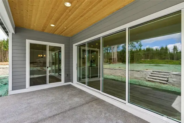 Spacious covered patio w/pine soffit, accessed from great room via the multi-panel glass wall slider, or the dining area via the two panel slider. Open both for fabulous indoor/ouitdoor living and entertaining!