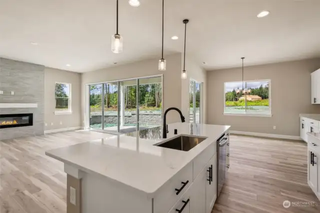 Gourmet island kitchen highlighted by quartz slab, undermount sink and GE SS appliance package including range hood and French door fridge!