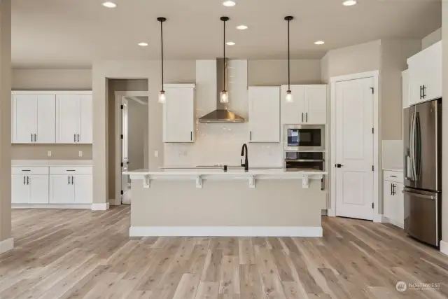 View of kitchen. Built-in buffet with upper cabs in the dining area shown on the left