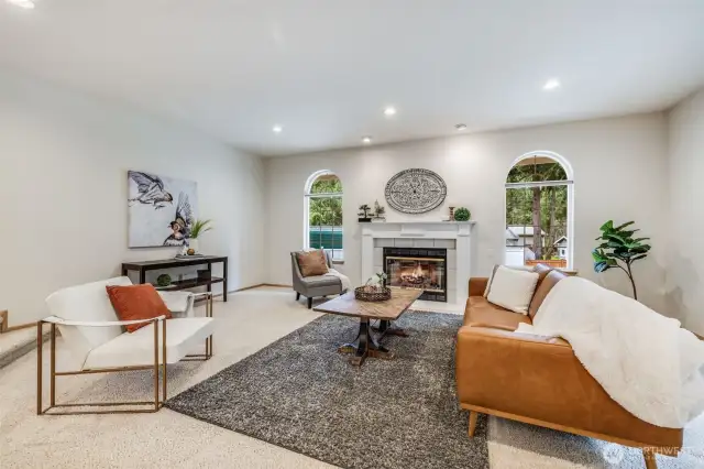 Bright living room with gas fireplace.
