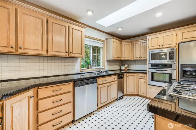 Beautiful kitchen with stainless steel appliances including trash compactor.