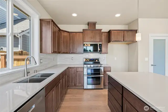 Sable-stained maple cabinets throughout home. Double oven is standard