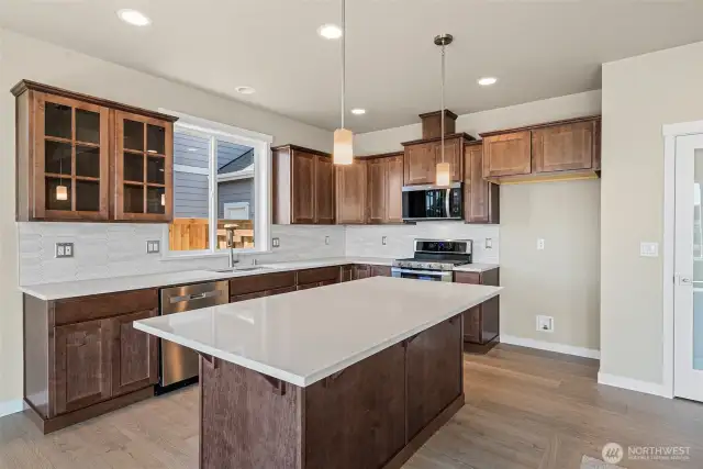 Quartz counters throughout the home. Look at that awesome island, perfect for prepping and entertaining